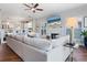 Bright living room featuring a cozy fireplace, a large sectional sofa, and an open floor plan at 1720 Kestral Park S Way # 49, Sarasota, FL 34231