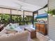 Comfortable sunroom with a plush sofa, large windows overlooking lush greenery, and a modern television at 1720 Kestral Park S Way # 49, Sarasota, FL 34231