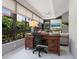Bright office featuring a wooden desk, comfortable chair, and large windows with a view at 1720 Kestral Park S Way # 49, Sarasota, FL 34231