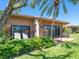 Outdoor patio with seating and manicured landscaping at 1720 Kestral Park S Way # 49, Sarasota, FL 34231