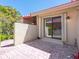 Private patio surrounded by a wall, pavers, and tropical plants with a view through the sliding glass door at 1720 Kestral Park S Way # 49, Sarasota, FL 34231