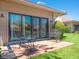 Inviting patio space featuring a table and chairs outside sliding glass doors at 1720 Kestral Park S Way # 49, Sarasota, FL 34231