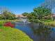 Scenic pond with a fountain, trees, flowers and landscaping at 1720 Kestral Park S Way # 49, Sarasota, FL 34231