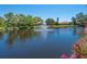 Picturesque pond view featuring a fountain and beautiful landscaping at 1720 Kestral Park S Way # 49, Sarasota, FL 34231