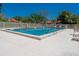 Community pool features a safety fence, lounge chairs, and a sparkling blue pool with depth markings at 1720 Kestral Park S Way # 49, Sarasota, FL 34231