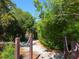 Explore the community's charming walking path, surrounded by beautiful trees and scenic views at 1720 Kestral Park S Way # 49, Sarasota, FL 34231