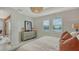 Bright bedroom featuring a dresser and large windows with shutters offering serene outdoor views at 17946 Cherished Loop, Bradenton, FL 34211
