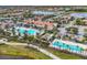 Aerial view of IslandWalk community pool and amenities, including lap pool, lounge chairs and clubhouse at 19138 Kirella St, Venice, FL 34293