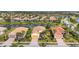 Aerial shot of homes in a lakeside community with lush landscaping and well-maintained lawns at 19138 Kirella St, Venice, FL 34293