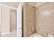 Bathroom with neutral walls, tiled shower, and white door at 19138 Kirella St, Venice, FL 34293