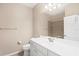 Cozy bathroom with tile flooring, white vanity, and well-lit mirror at 19138 Kirella St, Venice, FL 34293