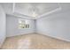 Spacious bedroom with tile floors, neutral walls, and a bright window at 19138 Kirella St, Venice, FL 34293