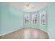 Bright bedroom with tile flooring, ceiling fan, and three windows at 19138 Kirella St, Venice, FL 34293