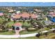 Expansive clubhouse with red tile roof, manicured lawns, palm trees, and a covered gazebo within the IslandWalk community at 19138 Kirella St, Venice, FL 34293