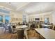 Spacious dining area with neutral tones, multiple tables and chairs, and views of palm trees through the door at 19138 Kirella St, Venice, FL 34293