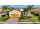 Charming single-Gathering home featuring a well-manicured lawn and a two-car garage at 19138 Kirella St, Venice, FL 34293