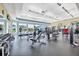 Bright gym featuring modern exercise equipment, mirrored walls, black matting, and beautiful window views at 19138 Kirella St, Venice, FL 34293