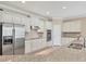 Bright kitchen features stainless steel appliances, granite countertops, and white cabinetry at 19138 Kirella St, Venice, FL 34293