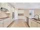 Bright kitchen features stainless steel appliances, granite countertops, and white cabinetry at 19138 Kirella St, Venice, FL 34293