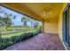Screened-in lanai featuring a brick floor and a tranquil view of the lake and lush landscaping at 19138 Kirella St, Venice, FL 34293
