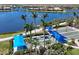 Aerial of lawn bowling setup with covered blue shades, landscaping, walking paths, and a lake in the background at 19138 Kirella St, Venice, FL 34293