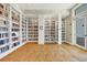 Well-stocked library with floor-to-ceiling white bookshelves and stylish carpet, lit by recessed lighting at 19138 Kirella St, Venice, FL 34293