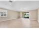 Open-concept living room with tile floors, neutral walls, and sliding glass doors at 19138 Kirella St, Venice, FL 34293