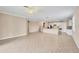 Open-concept living room with tile floors, neutral walls, and easy kitchen access at 19138 Kirella St, Venice, FL 34293