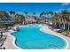 Spacious swimming pool with plenty of lounge seating and shade, surrounded by palm trees in IslandWalk community at 19138 Kirella St, Venice, FL 34293