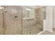 Modern tiled shower featuring glass door, built-in seat, and convenient grab bars at 19138 Kirella St, Venice, FL 34293