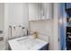 Bathroom featuring a white basin, marble counter, gold faucet, and vanity mirror at 238 Island Cir, Sarasota, FL 34242