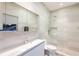 Elegant bathroom featuring a shower, and a large mirror, complemented by sleek tiling at 238 Island Cir, Sarasota, FL 34242