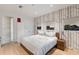 Serene bedroom with a tree-themed wallpaper accent wall and light-colored wood flooring at 238 Island Cir, Sarasota, FL 34242