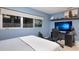 Blue bedroom features a large window, sleek desk, and modern decor perfect for a study or relaxing space at 238 Island Cir, Sarasota, FL 34242