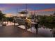 A boat on a lift on a canal behind the home at sunset at 238 Island Cir, Sarasota, FL 34242