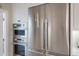 Kitchen features stainless steel appliances including double door fridge and built in oven and microwave at 238 Island Cir, Sarasota, FL 34242