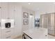 Bright kitchen features white cabinetry, stainless steel appliances, and a center island with quartz countertops at 238 Island Cir, Sarasota, FL 34242