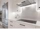 Modern kitchen with sleek countertops, stainless steel appliances, herringbone backsplash, and stylish range hood at 238 Island Cir, Sarasota, FL 34242