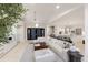 Open concept living space with modern decor, including a large sectional sofa and sleek black framed doors at 238 Island Cir, Sarasota, FL 34242