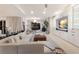 Bright, open-concept living room with a cozy sectional, built-in shelving, and a view of the outdoors at 238 Island Cir, Sarasota, FL 34242
