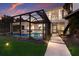 Beautiful backyard pool enclosed in lanai with seating at 238 Island Cir, Sarasota, FL 34242