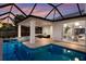 Screened-in pool and spa with covered patio and outdoor seating area for entertaining at 238 Island Cir, Sarasota, FL 34242