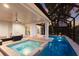 Backyard pool and spa with fire pit, covered patio, and tranquil waterfront views at 238 Island Cir, Sarasota, FL 34242