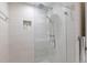 A contemporary shower with glass enclosure, rainfall showerhead, and tiled niche for storage at 238 Island Cir, Sarasota, FL 34242
