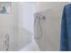 Modern shower featuring sleek fixtures, glass door, and built-in shelf for toiletries at 238 Island Cir, Sarasota, FL 34242