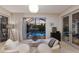 Cozy sitting area with pool views through a screened lanai, featuring plush chairs and modern decor at 238 Island Cir, Sarasota, FL 34242