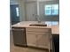 Modern kitchen featuring stainless steel appliances, sink and faucet, cabinets, and quartz countertops at 240 Ibiza Loop, Venice, FL 34292