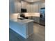 Well-equipped kitchen with stainless steel appliances, quartz countertops, and stylish cabinetry at 240 Ibiza Loop, Venice, FL 34292