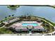 An aerial view of the pool, beach entry, Tiki huts, and bocce ball court at 240 Ibiza Loop, Venice, FL 34292