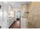 Bright bathroom featuring a dual sink vanity with granite countertop and a glass enclosed shower at 241 Sapphire Lake Dr # 201, Bradenton, FL 34209